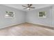 Spacious bedroom featuring light grey walls and wood-look tile floors at 8402 Bedford Ln, Tampa, FL 33615