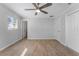 Spacious bedroom with light walls, wood-look floors and two windows at 8402 Bedford Ln, Tampa, FL 33615