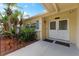 White double front doors with sidelights and black railing at 8402 Bedford Ln, Tampa, FL 33615