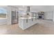 Bright kitchen featuring white cabinets, a large island, and stainless steel appliances at 8402 Bedford Ln, Tampa, FL 33615