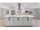 Large kitchen island with white cabinets and quartz countertop at 8402 Bedford Ln, Tampa, FL 33615