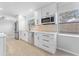 Modern kitchen with white cabinets, stainless steel appliances and tile flooring at 8402 Bedford Ln, Tampa, FL 33615
