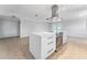 Modern kitchen with white cabinets, island, and stainless steel appliances at 8402 Bedford Ln, Tampa, FL 33615