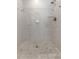 Walk-in shower with neutral tile and glass enclosure at 8402 Bedford Ln, Tampa, FL 33615