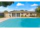 Inviting swimming pool, steps, and spacious backyard at 8402 Bedford Ln, Tampa, FL 33615