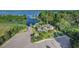 Scenic aerial view of home with lush landscaping, private boat dock, and lake access at 10603 Low Oak Ter, Thonotosassa, FL 33592