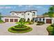 Elegant estate with manicured landscaping and a circular driveway leading to a three-car garage at 10603 Low Oak Ter, Thonotosassa, FL 33592