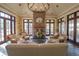 Inviting lounge area with a stone fireplace, comfortable seating, and ample natural light at 10603 Low Oak Ter, Thonotosassa, FL 33592