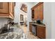 Butler's pantry with wine storage, beverage fridge, and granite countertop at 10603 Low Oak Ter, Thonotosassa, FL 33592