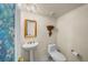 Powder room with pedestal sink, decorative mirror and stained glass accent at 1661 Watermark Ne Cir, St Petersburg, FL 33702