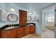 Bathroom showcasing double sink vanity with granite countertop and step-up tub/shower at 1661 Watermark Ne Cir, St Petersburg, FL 33702