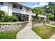 Charming exterior of a waterfront home with lush landscaping and a welcoming entrance at 1661 Watermark Ne Cir, St Petersburg, FL 33702
