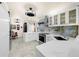 Modern kitchen features stainless appliances, white cabinets and marble backsplash at 1661 Watermark Ne Cir, St Petersburg, FL 33702