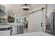 Modern kitchen with open floorplan features stainless appliances, white cabinets and access to great room at 1661 Watermark Ne Cir, St Petersburg, FL 33702