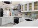 Modern kitchen features stainless appliances, white cabinets and marble backsplash at 1661 Watermark Ne Cir, St Petersburg, FL 33702