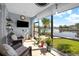 Enclosed lanai with comfortable seating and a view of the serene canal at 1661 Watermark Ne Cir, St Petersburg, FL 33702