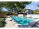 Relaxing pool area with a large pool surrounded by brick pavers and landscaping at community at 1661 Watermark Ne Cir, St Petersburg, FL 33702