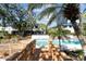 Inviting community pool area with wooden deck, lounge chairs, and surrounding mature trees at 1661 Watermark Ne Cir, St Petersburg, FL 33702