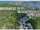 Aerial view showcasing a light blue house nestled in a community near a body of water at 5112 Coastal Scene Dr, Apollo Beach, FL 33572