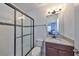 Bathroom boasts a large shower, granite vanity, and updated fixtures at 5112 Coastal Scene Dr, Apollo Beach, FL 33572