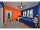 Spacious bedroom with colorful walls, ceiling fan, and en-suite bathroom at 5112 Coastal Scene Dr, Apollo Beach, FL 33572