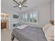 Cozy bedroom with ceiling fan, window shutters, and en-suite bathroom at 5112 Coastal Scene Dr, Apollo Beach, FL 33572
