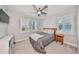 Bright bedroom with ceiling fan, window shutters, and ample closet space at 5112 Coastal Scene Dr, Apollo Beach, FL 33572