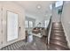 Bright and airy entryway with hardwood floors, staircase, and cozy sitting area at 5112 Coastal Scene Dr, Apollo Beach, FL 33572