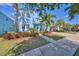 Two-story light blue house with palm trees and a paved driveway at 5112 Coastal Scene Dr, Apollo Beach, FL 33572