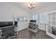 Home office with hardwood floors, large window, and built-in desk at 5112 Coastal Scene Dr, Apollo Beach, FL 33572