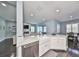 Modern kitchen with a farmhouse sink and white cabinetry at 5112 Coastal Scene Dr, Apollo Beach, FL 33572