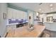 Eat-in kitchen with white cabinets, gray backsplash, and wood table at 5112 Coastal Scene Dr, Apollo Beach, FL 33572