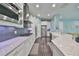 Modern kitchen with white cabinets, granite countertops, and stainless steel appliances at 5112 Coastal Scene Dr, Apollo Beach, FL 33572