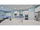 Modern kitchen with white cabinets, granite countertops, and stainless steel appliances at 5112 Coastal Scene Dr, Apollo Beach, FL 33572