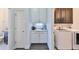 Convenient laundry room with washer, dryer, and extra storage at 5112 Coastal Scene Dr, Apollo Beach, FL 33572