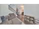 Open living room with hardwood floors, gray sofas, and built-in shelving at 5112 Coastal Scene Dr, Apollo Beach, FL 33572