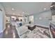 Open living room with kitchen views, featuring a sectional sofa and electric fireplace at 5112 Coastal Scene Dr, Apollo Beach, FL 33572