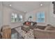 Spacious living room with hardwood floors, gray sofas, and a large window at 5112 Coastal Scene Dr, Apollo Beach, FL 33572