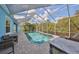 Relaxing screened pool and patio with outdoor kitchen and seating at 5112 Coastal Scene Dr, Apollo Beach, FL 33572