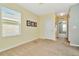 Spacious bedroom with large window, neutral walls, and carpet flooring at 121 Lacewing Pl, Valrico, FL 33594
