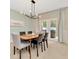 Bright dining room features a wood table, six chairs, and access to a backyard patio at 121 Lacewing Pl, Valrico, FL 33594
