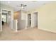 Upstairs hallway with carpet, doors to bedrooms, and ceiling fan at 121 Lacewing Pl, Valrico, FL 33594