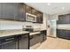 Modern kitchen with stainless steel appliances and dark cabinets at 121 Lacewing Pl, Valrico, FL 33594