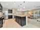 Modern kitchen with dark cabinetry, stainless steel appliances, and a large island at 121 Lacewing Pl, Valrico, FL 33594