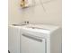 Laundry room with washer and dryer, and overhead shelving at 121 Lacewing Pl, Valrico, FL 33594