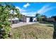 Spacious backyard with pergola, patio furniture, and grassy area at 4436 W Wallace Ave, Tampa, FL 33611