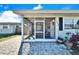 Inviting front porch with screened enclosure and seating at 4436 W Wallace Ave, Tampa, FL 33611