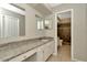 Bathroom featuring granite counters, white cabinets, and tiled shower at 10113 Tarragon Dr, Riverview, FL 33569