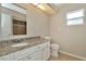 Bright bathroom featuring a granite vanity top, a toilet, and a shower with decorative tiling at 10113 Tarragon Dr, Riverview, FL 33569