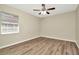 Bedroom featuring updated flooring, a ceiling fan with lights, and a window at 10113 Tarragon Dr, Riverview, FL 33569